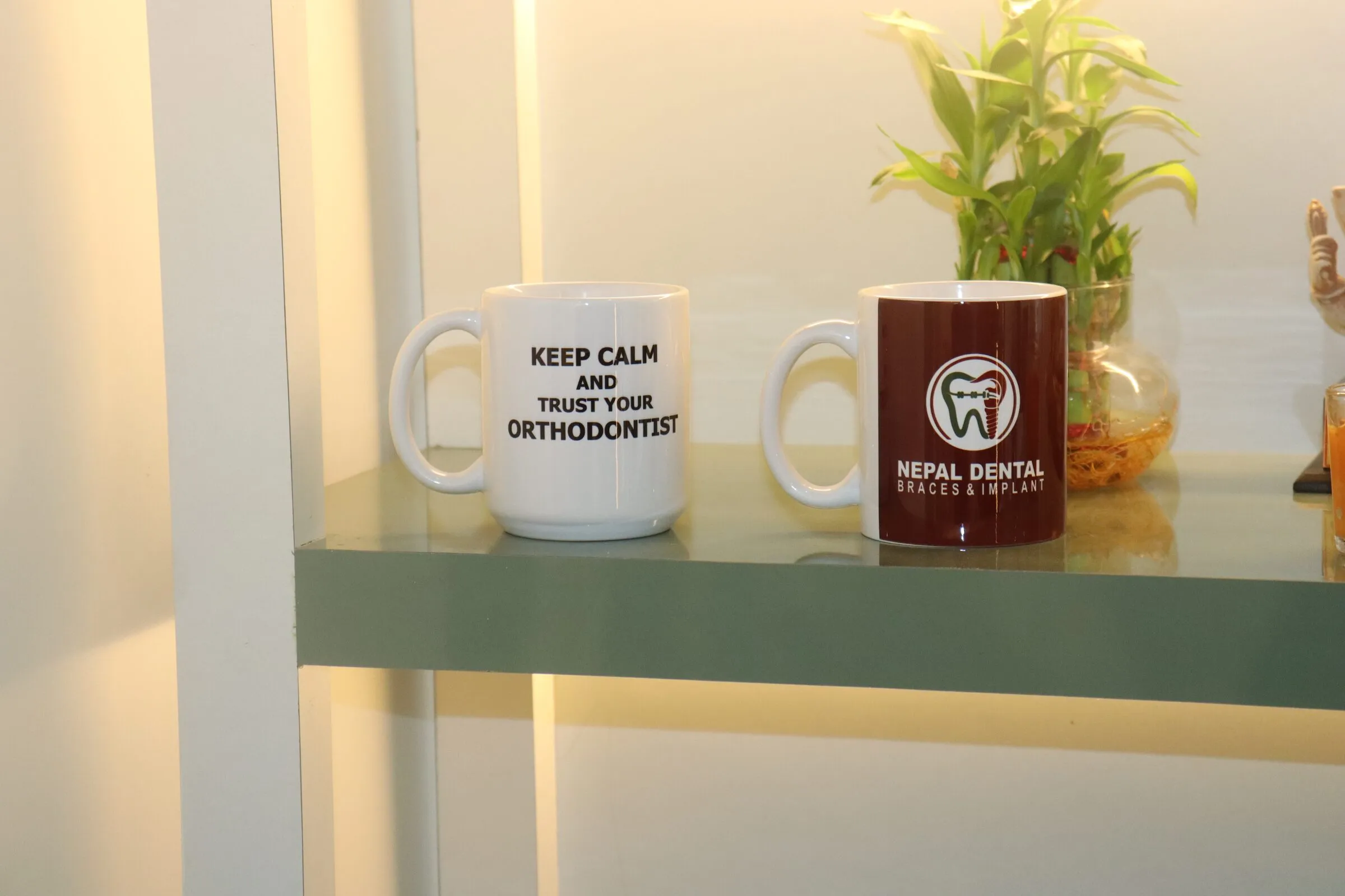 Clinic mugs reading “Keep calm and trust your orthodontist”